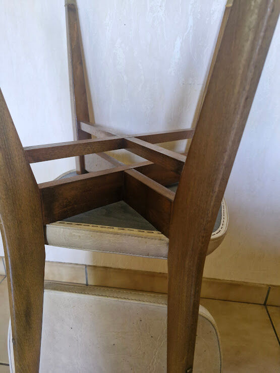 4 solid wood chairs with beige faux leather.