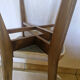 4 solid wood chairs with beige faux leather.