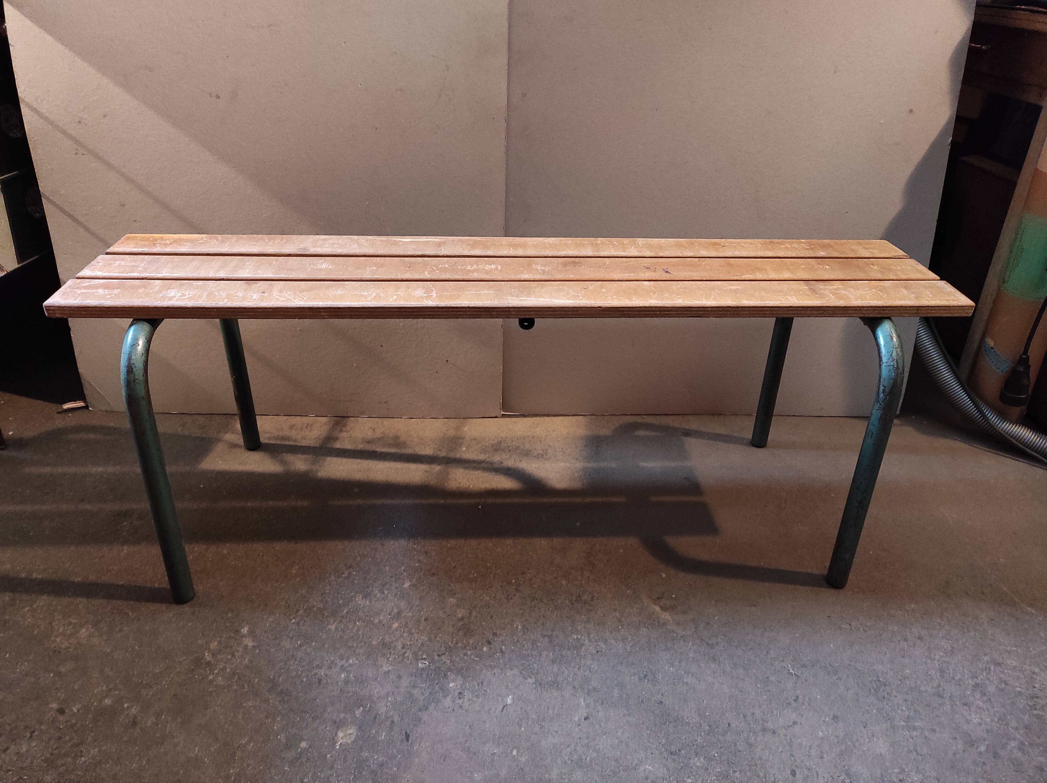 Former vintage wooden school bench and metal tubes
