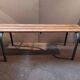 Former vintage wooden school bench and metal tubes