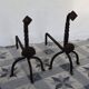 Vintage metal and cast iron fire dogs with shell motif.