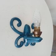 Antique wall light in enamelled cast iron.
