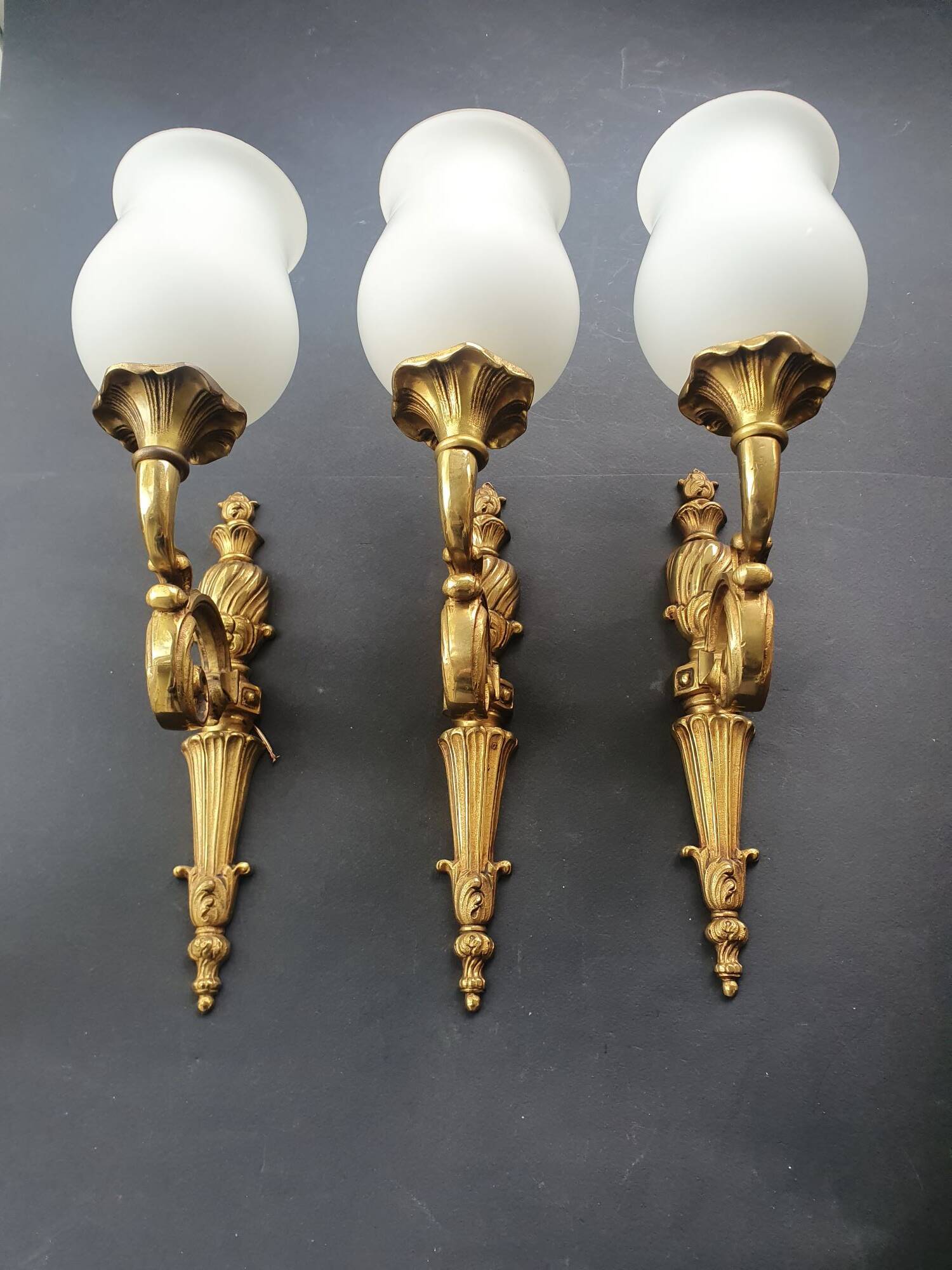 Three large vintage torch wall sconces.