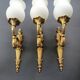 Three large vintage torch wall sconces.