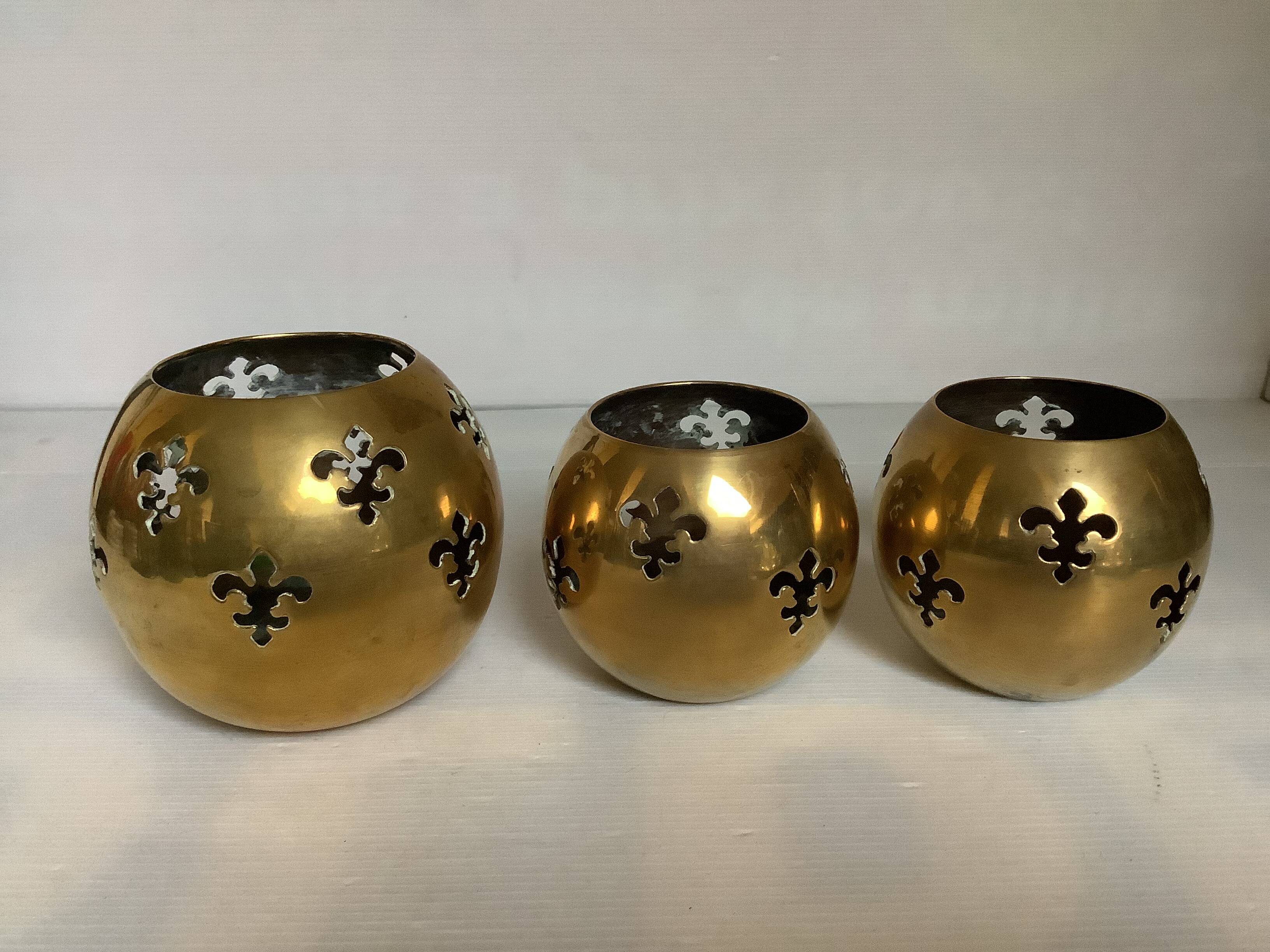 Trio of brass fleur-de-lis candle holders