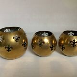 Trio of brass fleur-de-lis candle holders