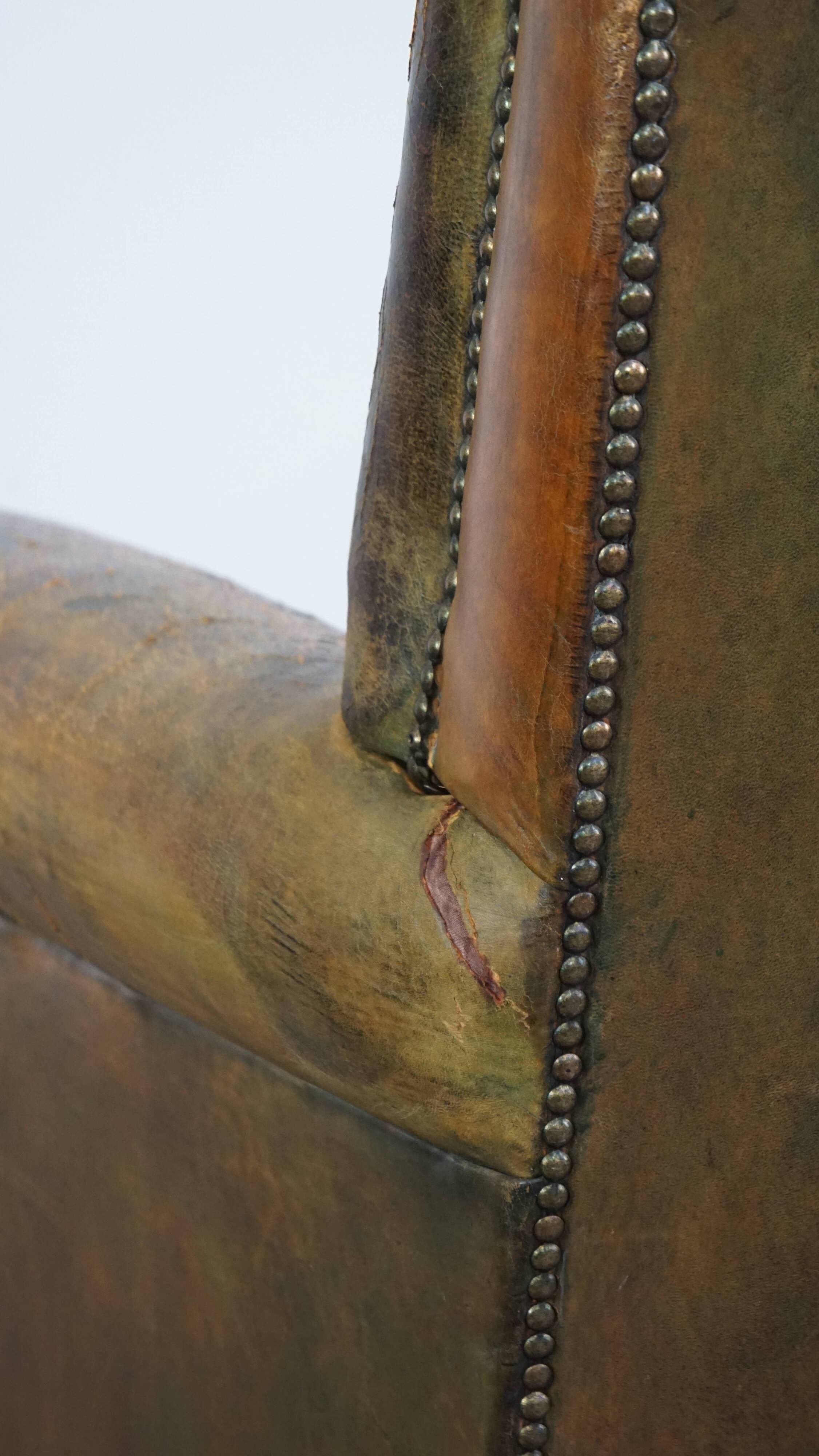 Green antique English cowhide leather armchair on wheels