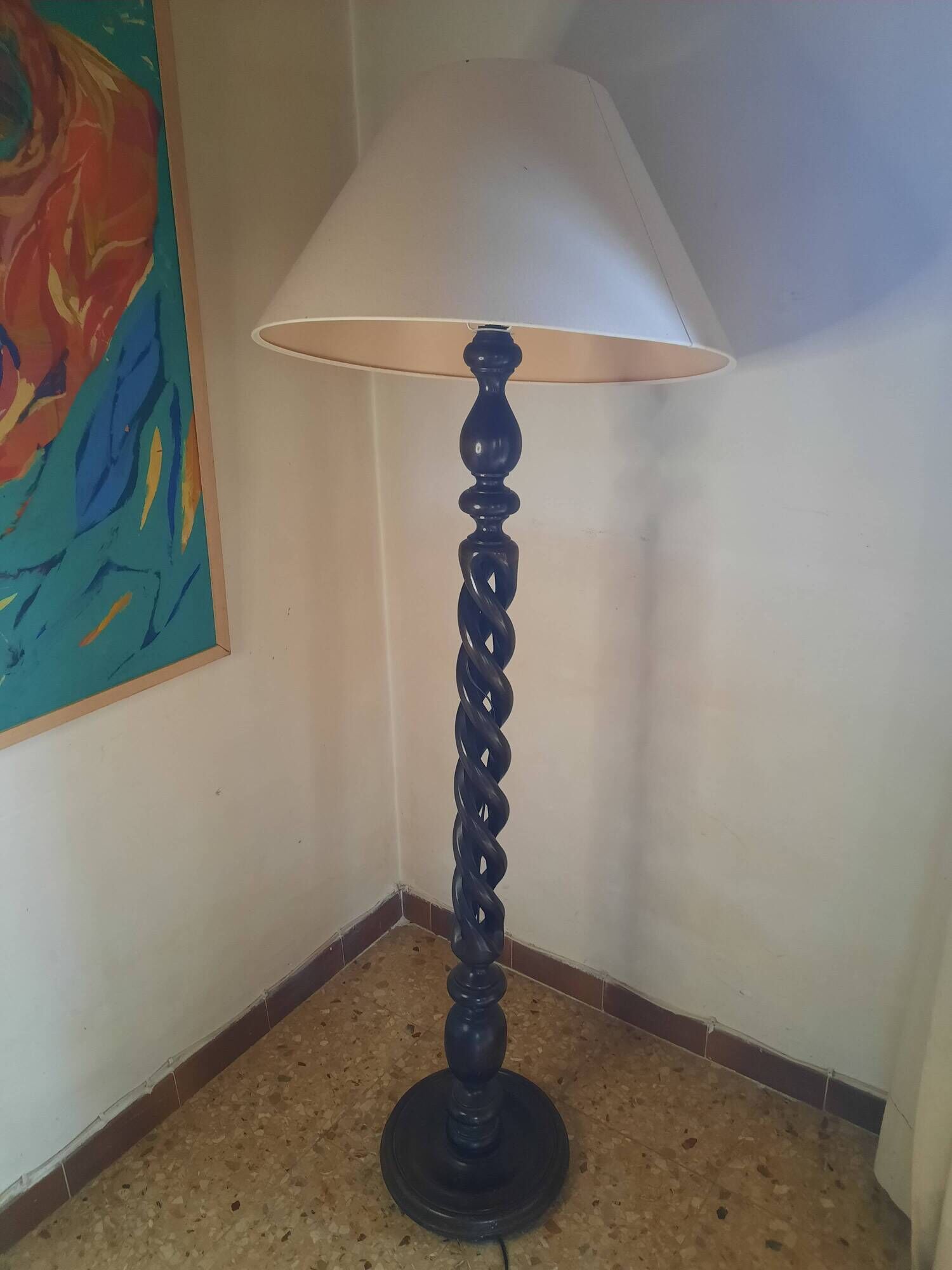 Sculptural floor lamp made of twisted turned wood.