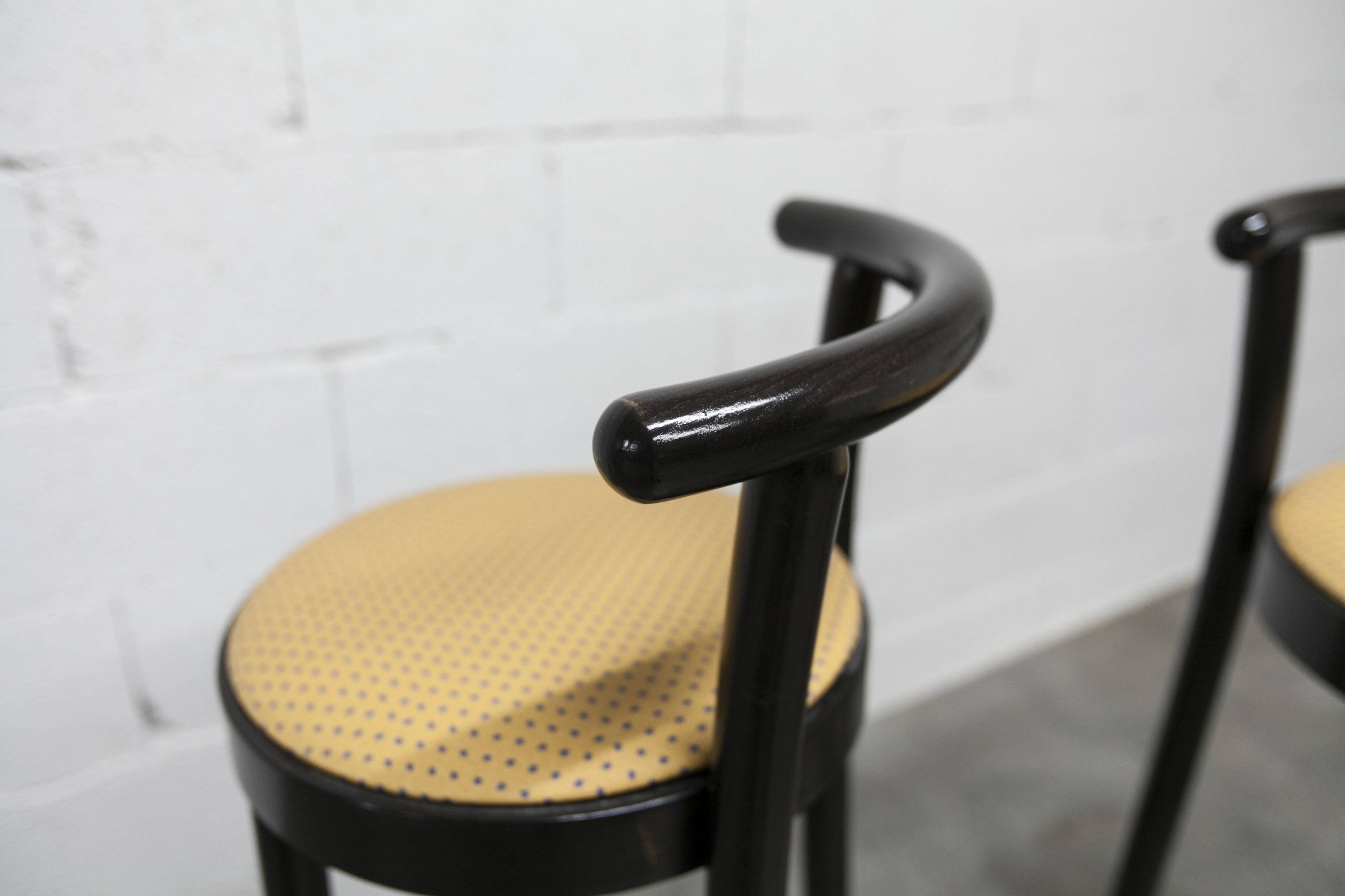Pair of Baumann Dialog model stools in black and yellow and blue imitation leather, 1990