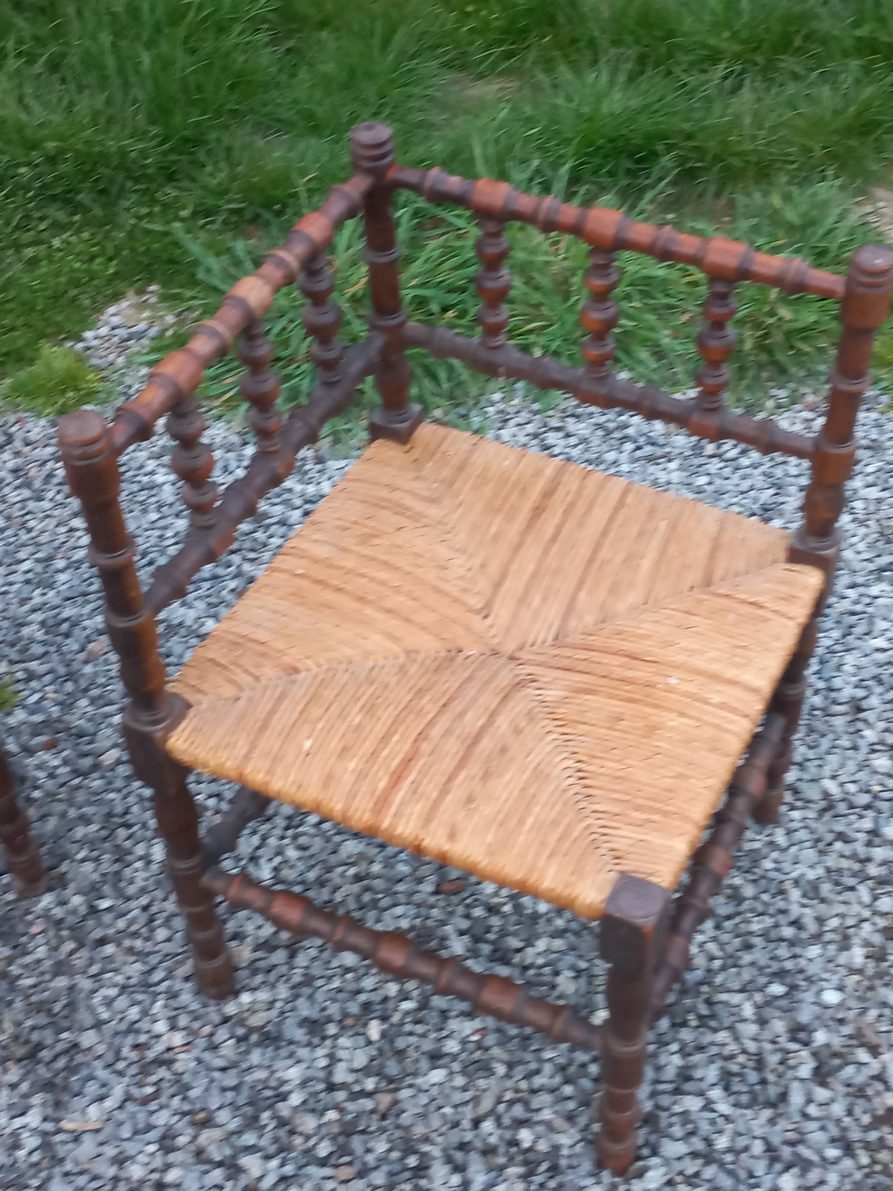 Pair of angled armchairs with turned wood and rush seats from the 1960s.