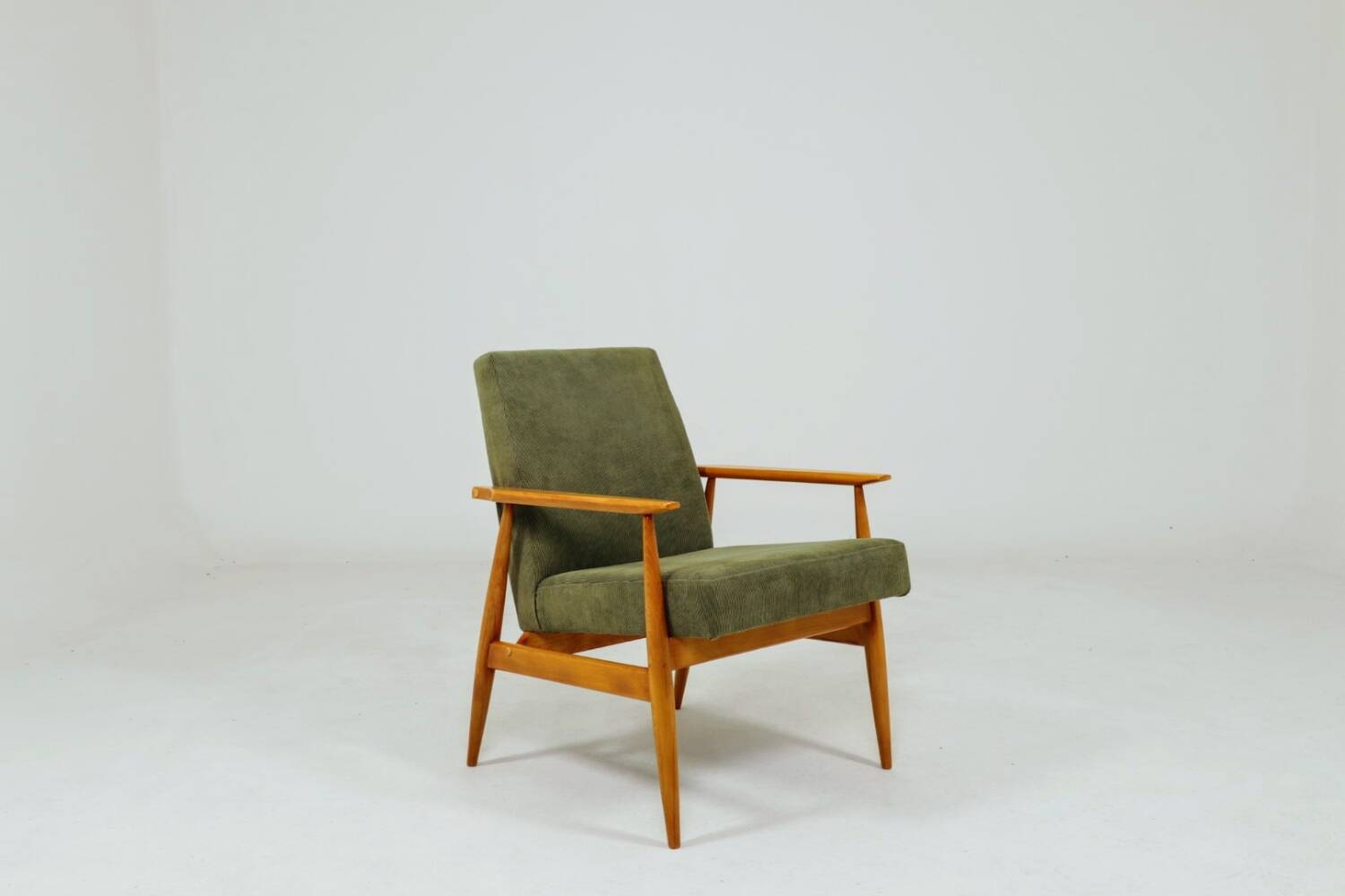 Mid-century modern design armchair in olive green corduroy.