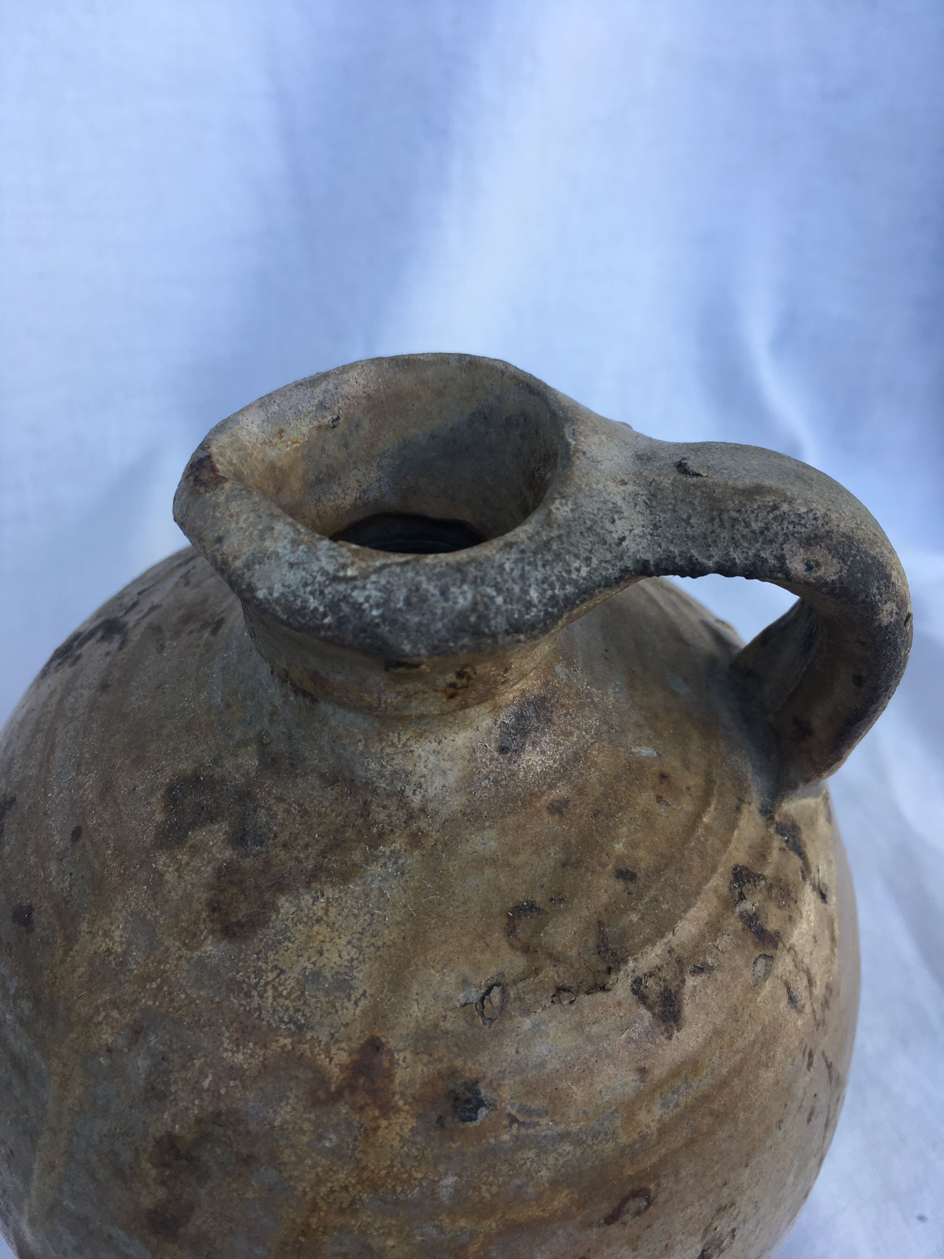 Ancient jug in glazed sandstone