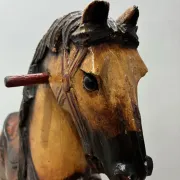Antique hand-carved rocking horse on wheels, early 20th century