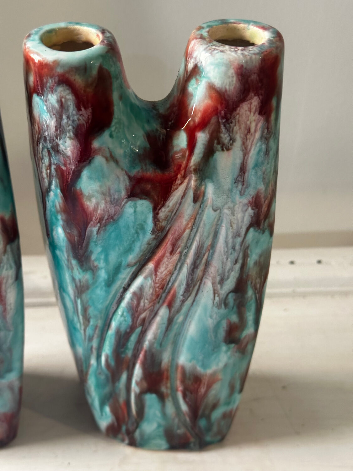 Vintage pair of turquoise and red ceramic candlesticks