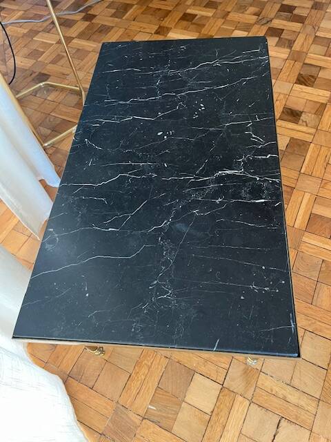 Black marble coffee table with brass legs.