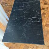 Black marble coffee table with brass legs.