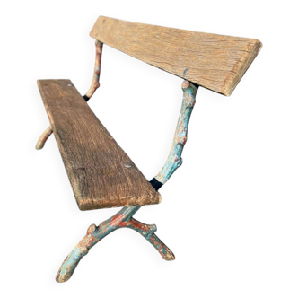 Vintage cast iron garden bench with wooden seat and backrest.