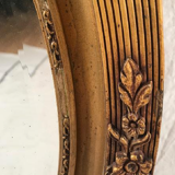 Mirror oval gilded stucco frame