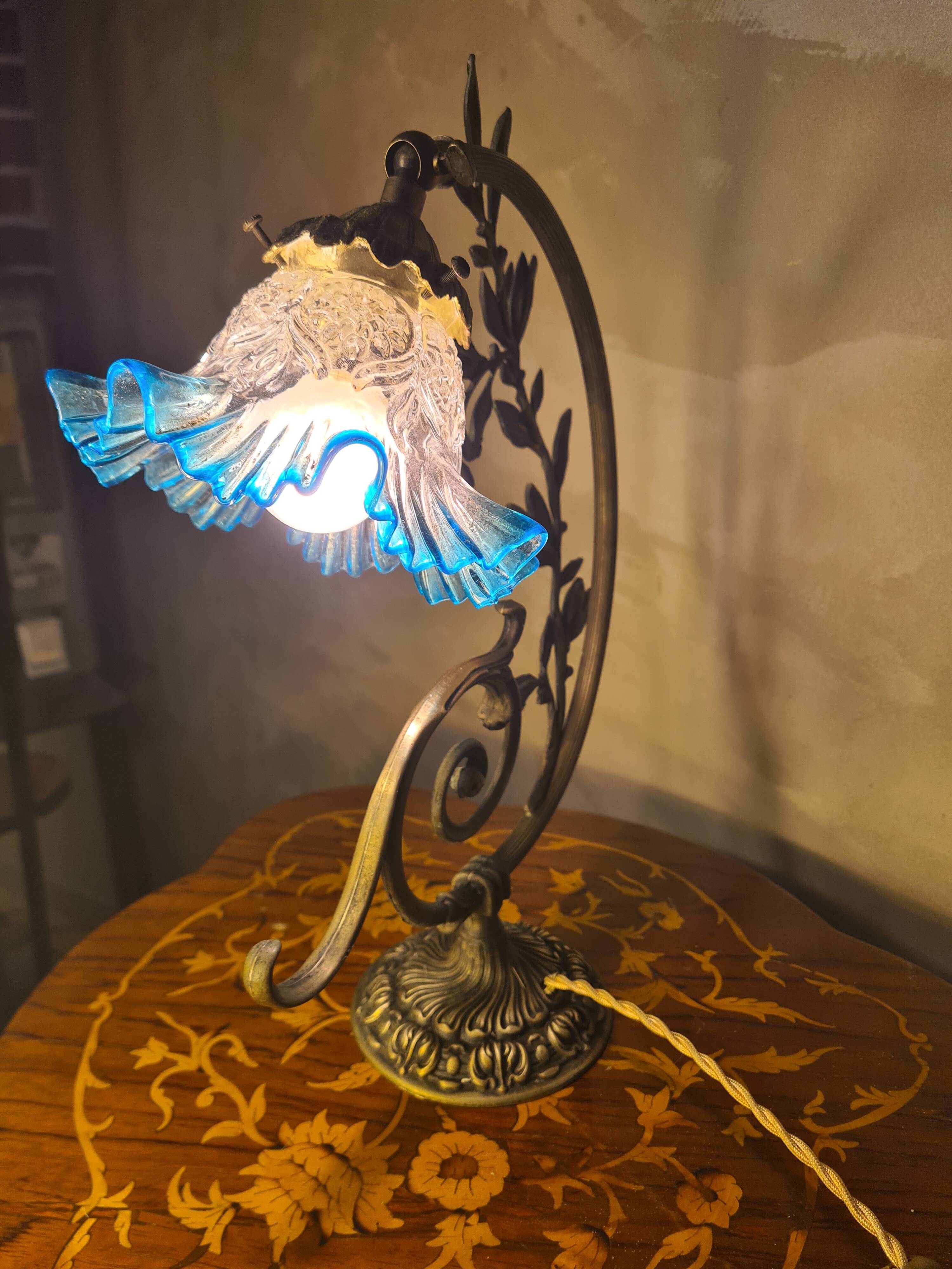 Bronze and brass lamp, transparent and blue glass shade.