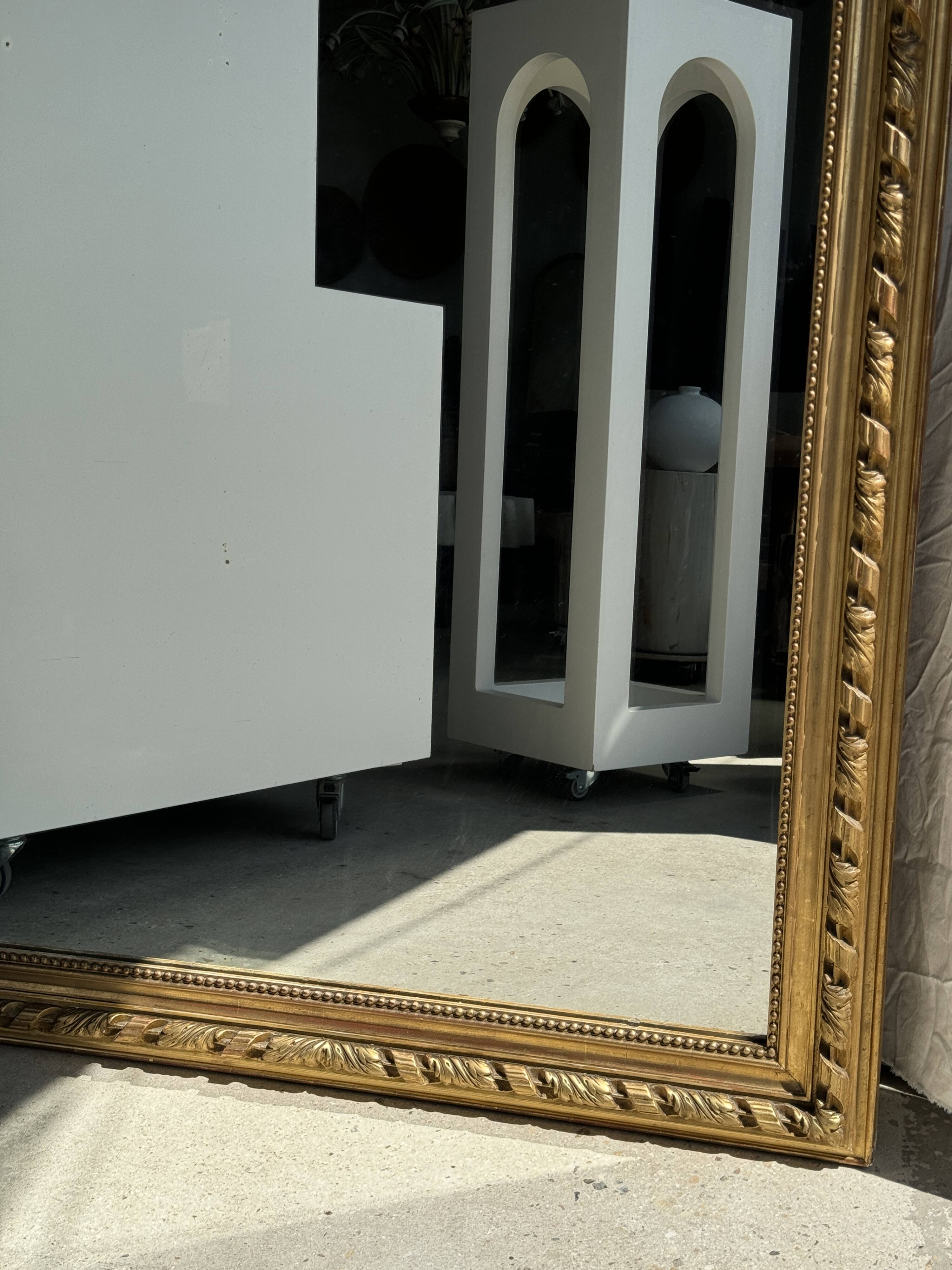 Large gilded mirror with acanthus leaf pediment H150 L98