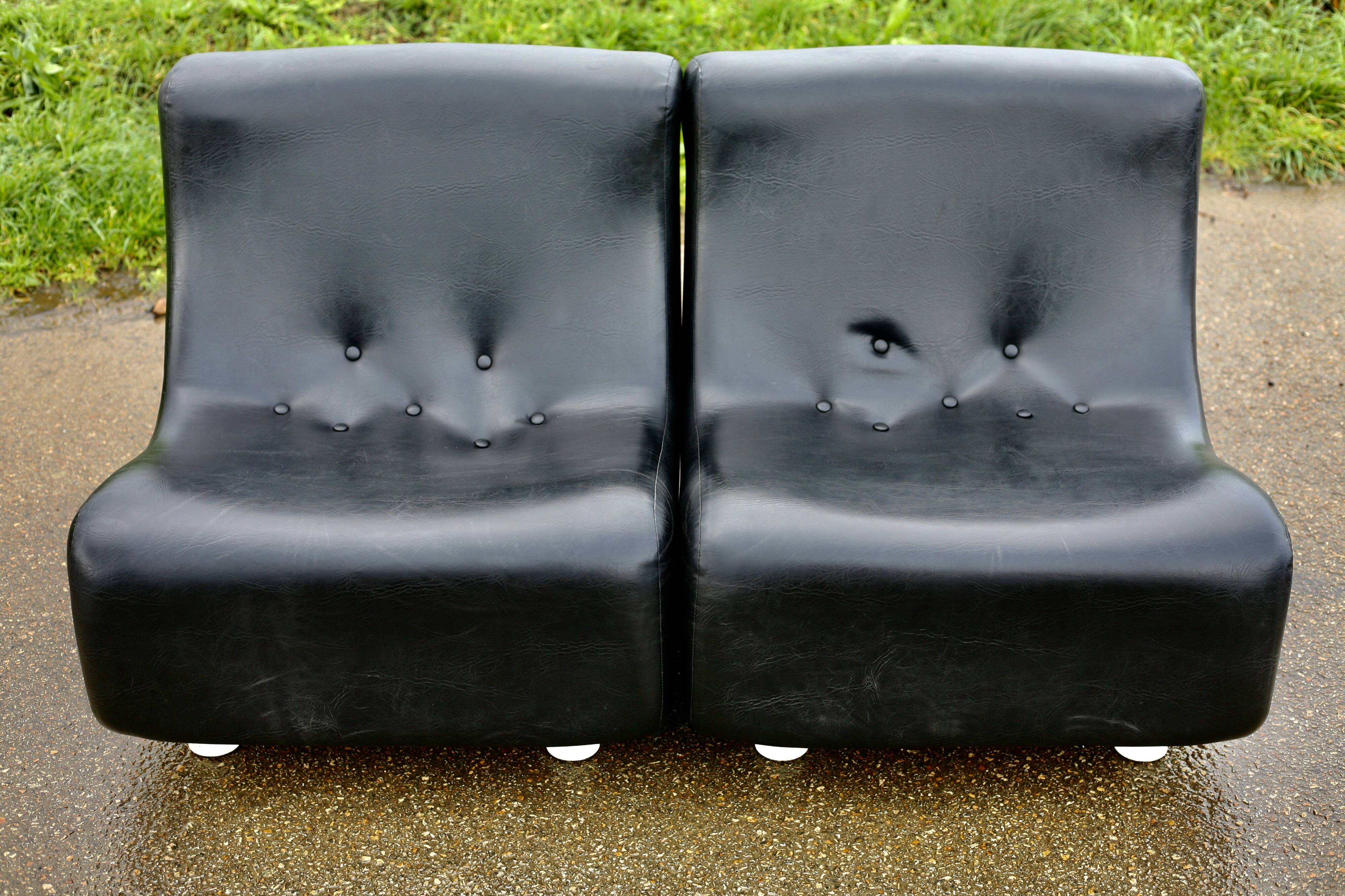 Pair of “space age” low chairs. Black faux leather. Circa 1970