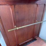 Antique wooden coat rack with mirror and shelf.