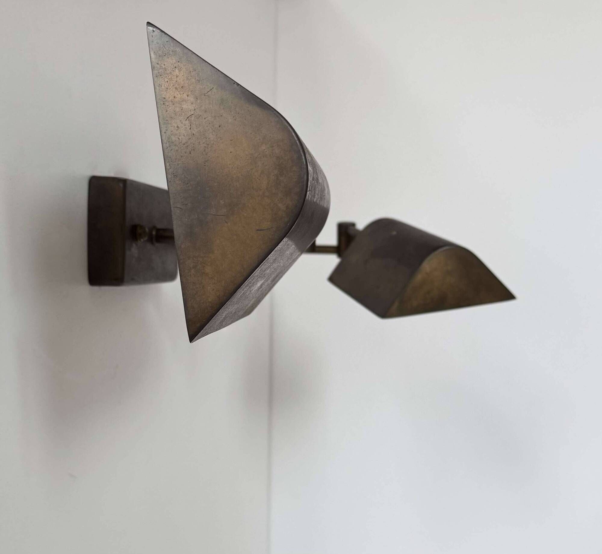 Pair of vintage adjustable wall lights, patinated brass, France 1970.