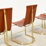 Set of four leather and brass Italian dining chairs