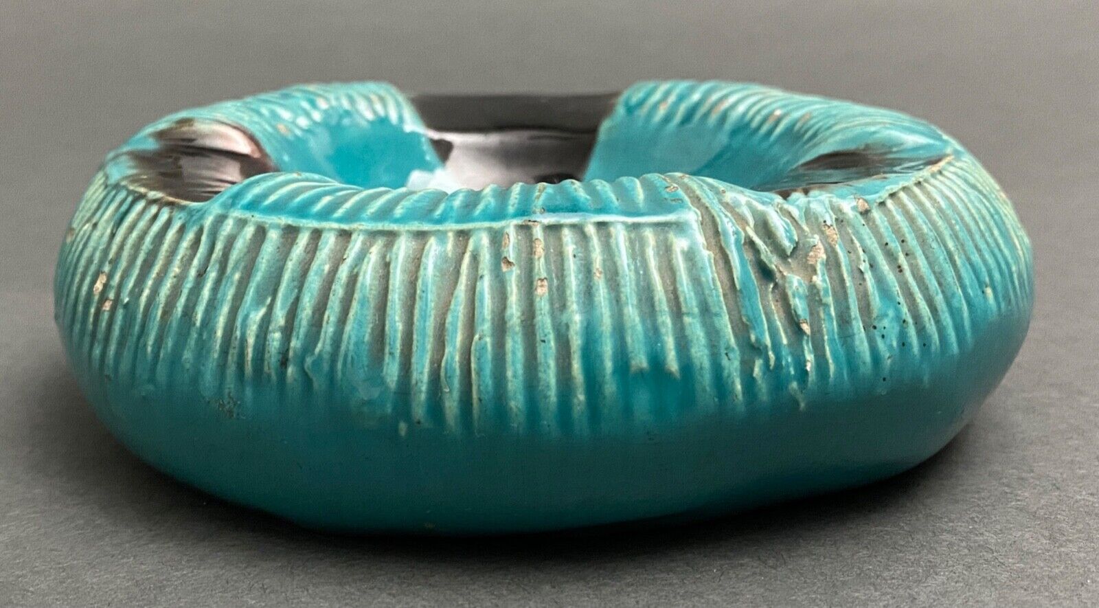 Twentieth century ceramic ashtray decorated with animals on a blue background