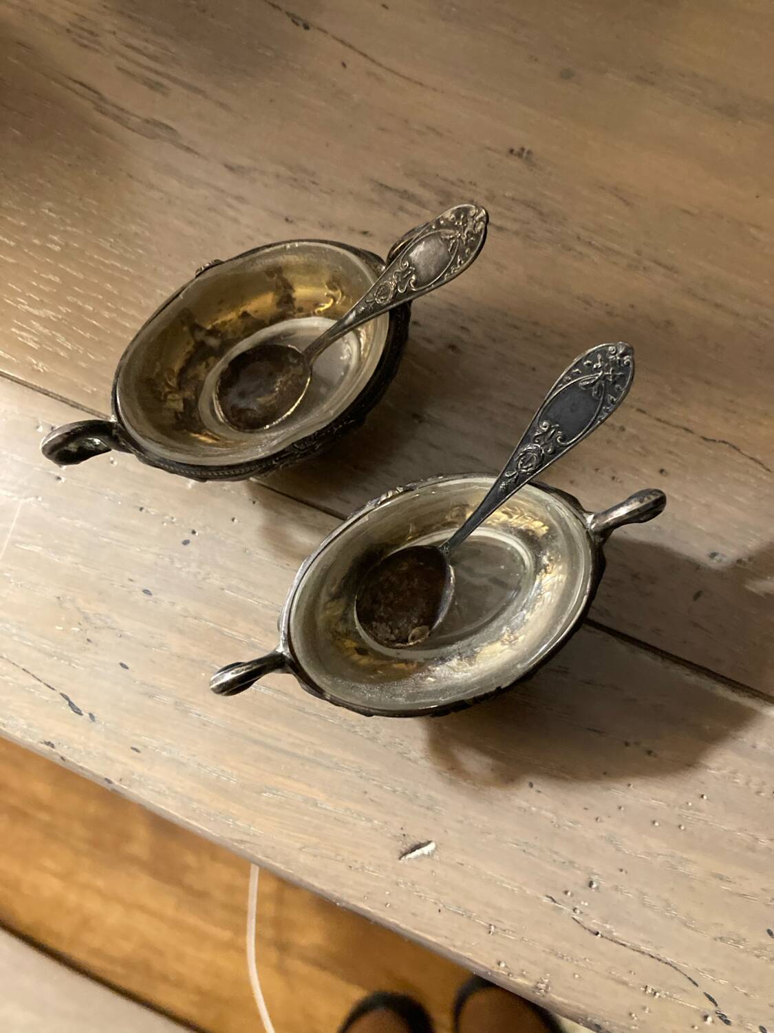 Salt and pepper shakers with silver spoons