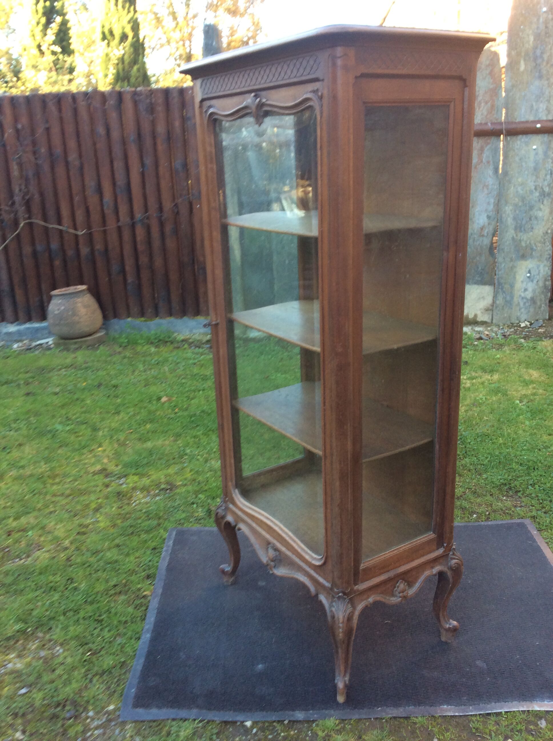 Louis XV Rocaille style showcase in solid walnut, beveled door glass.