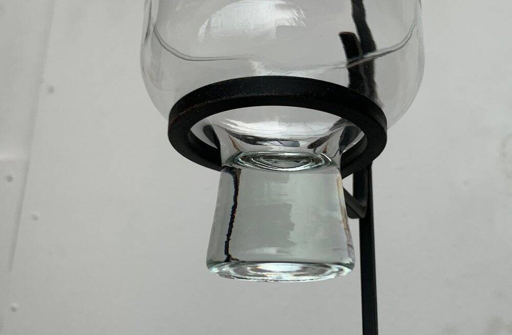 Mid-century metal and glass pendant light from the 1960s.
