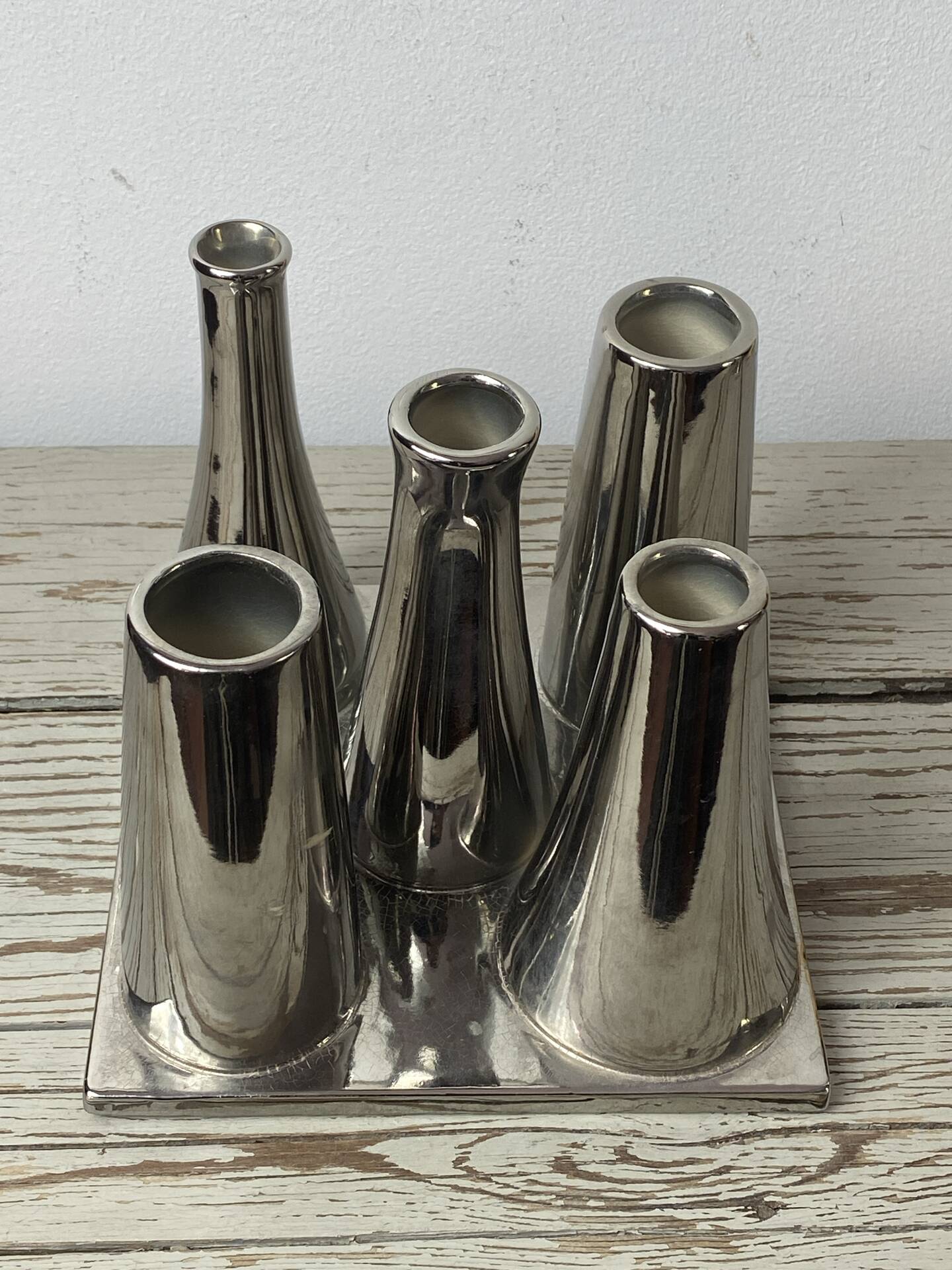 Asymmetrical multitube vase on a base, in silvered ceramic, 1970.