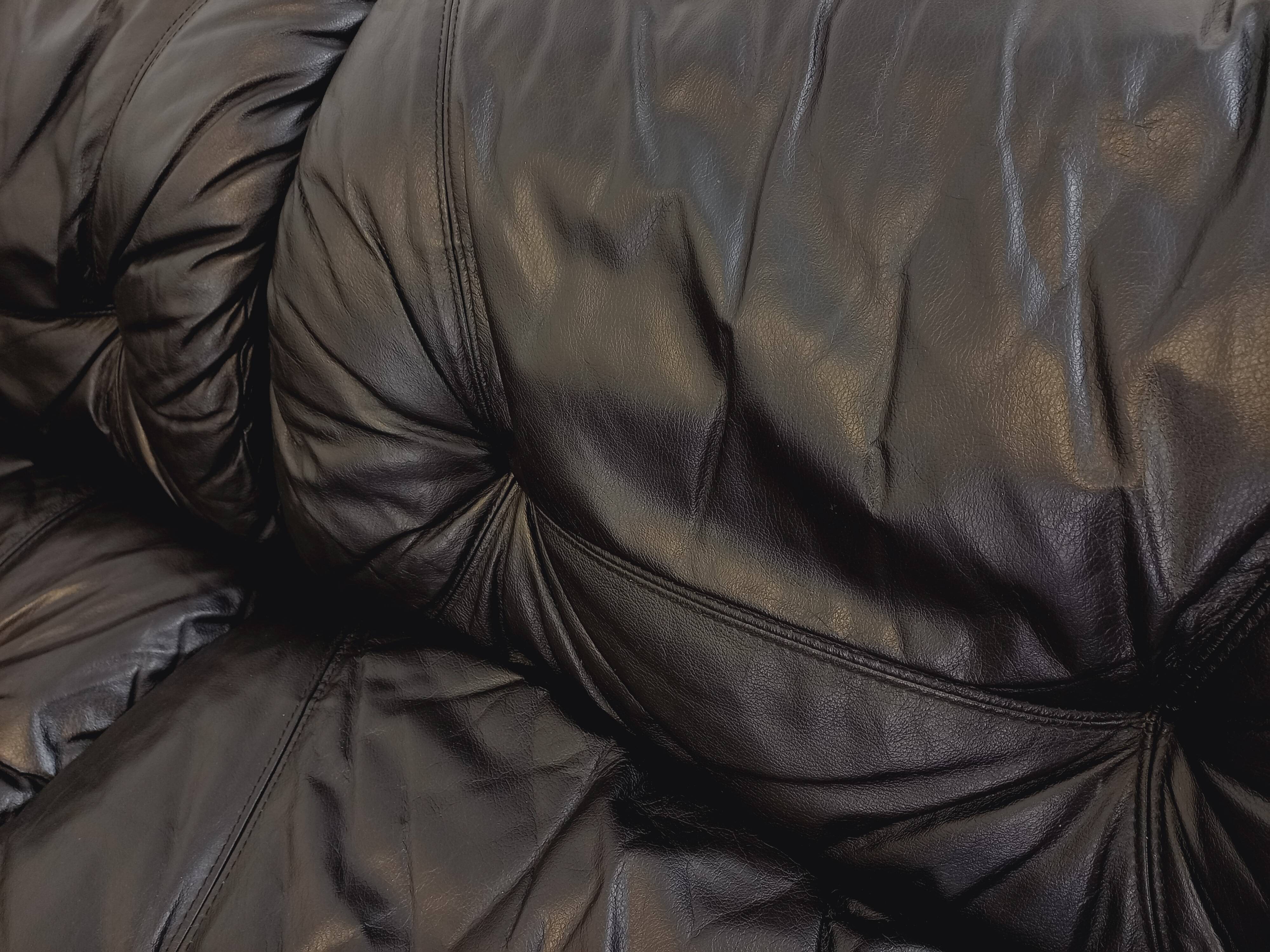 Vintage corner sofa composed of 3 modules in black leather with integrated bed.