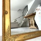 Antique gilded mirror from the Restoration period, 19th century.