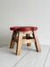 Small antique wooden stool with floral painted decoration.