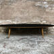 Oval coffee table with a black tray and oak-turned feet