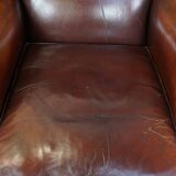 Dark English style sheepskin wingback chair with character and patina