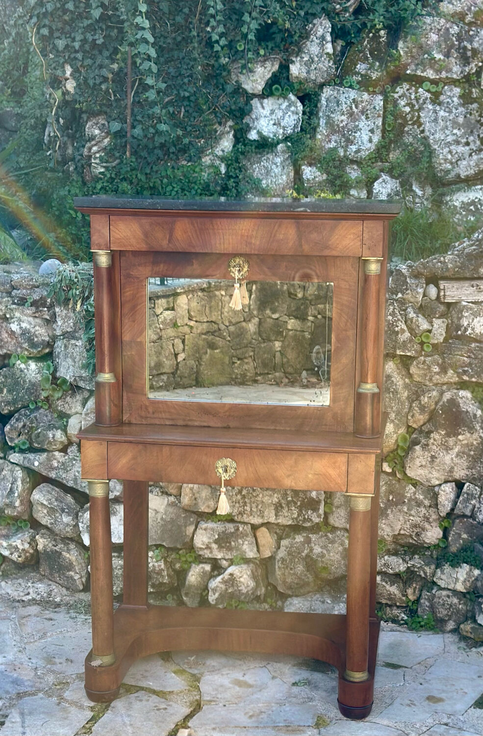 A small piece of Bonheur du jour with detached columns in Empire-era mahogany.