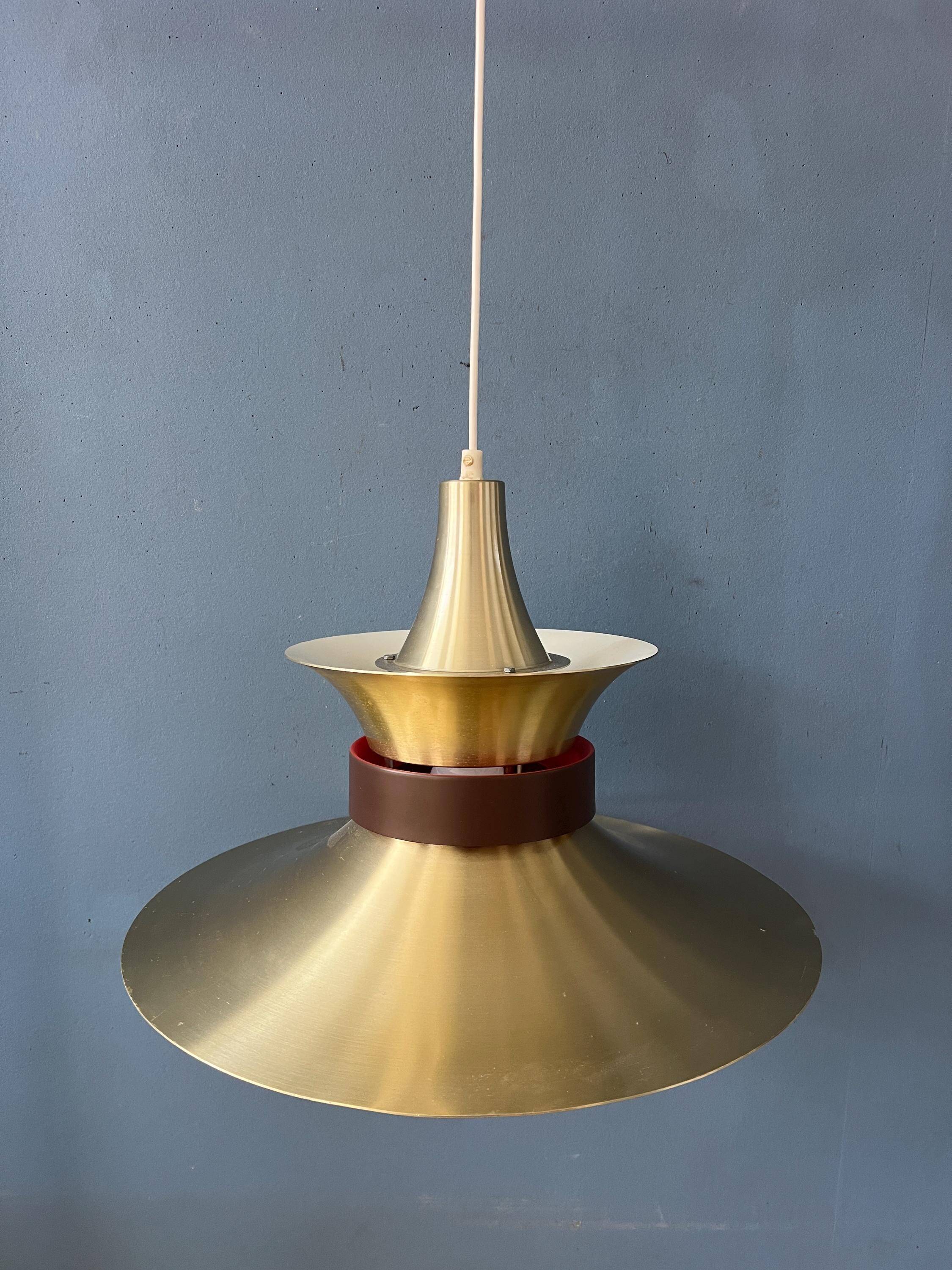 Large UFO flying saucer pendant light with orange light.