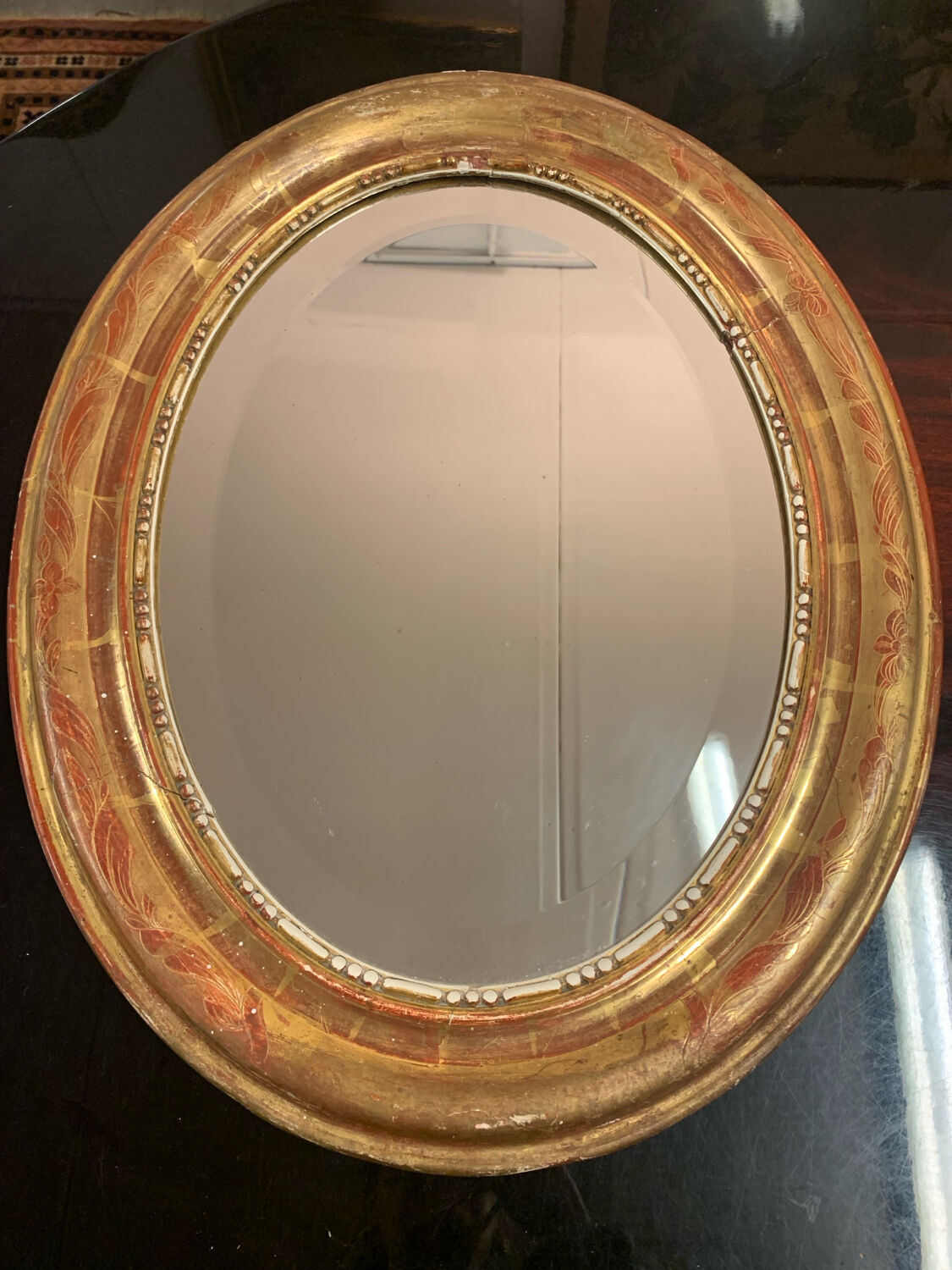 Golden oval mirror