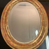 Golden oval mirror