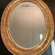 Golden oval mirror