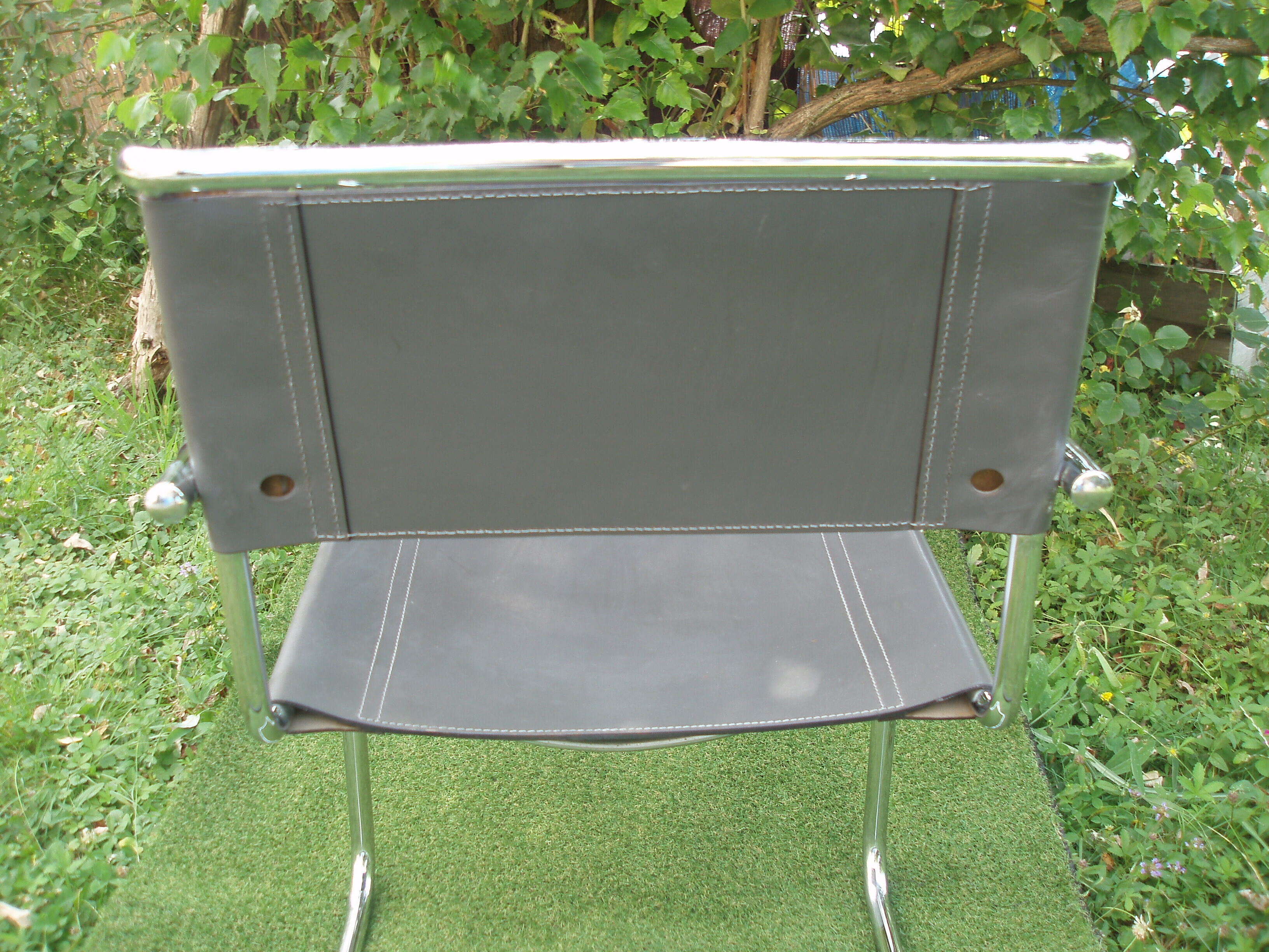 Series of grey and chrome leather armchairs