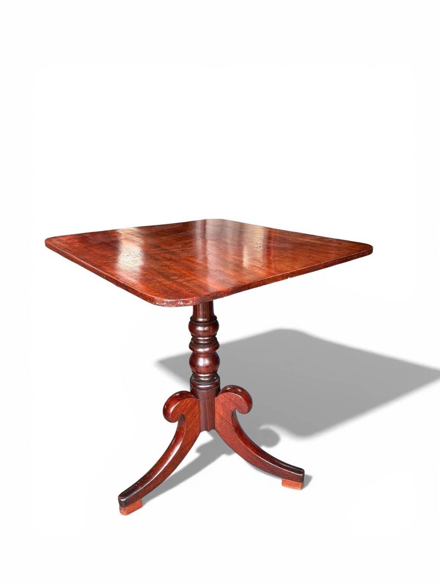 19th-century solid mahogany table with a tilting top and brass mechanism.