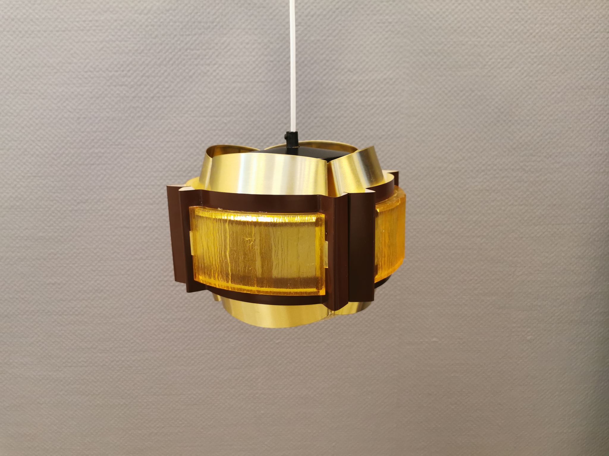 Danish hanging lamp, made in brass colored and brown metal, with yellowish hard pressed plastic deta
