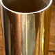 Set of candlesticks and tubular vases in solid brass.