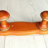 Wall-mounted coat rack in wood and brass
