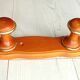 Wall-mounted coat rack in wood and brass