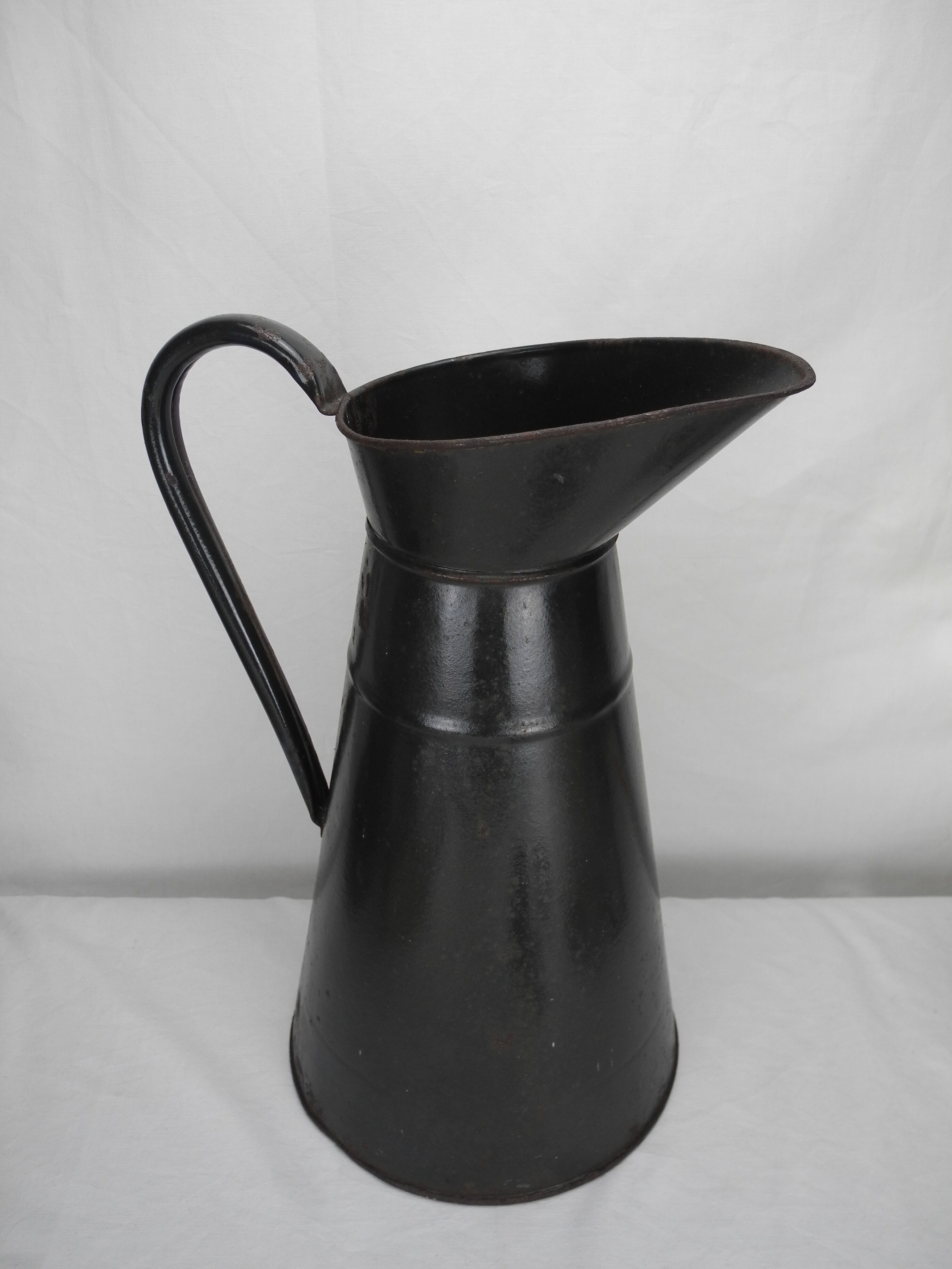 Old enamelled sheet metal jug